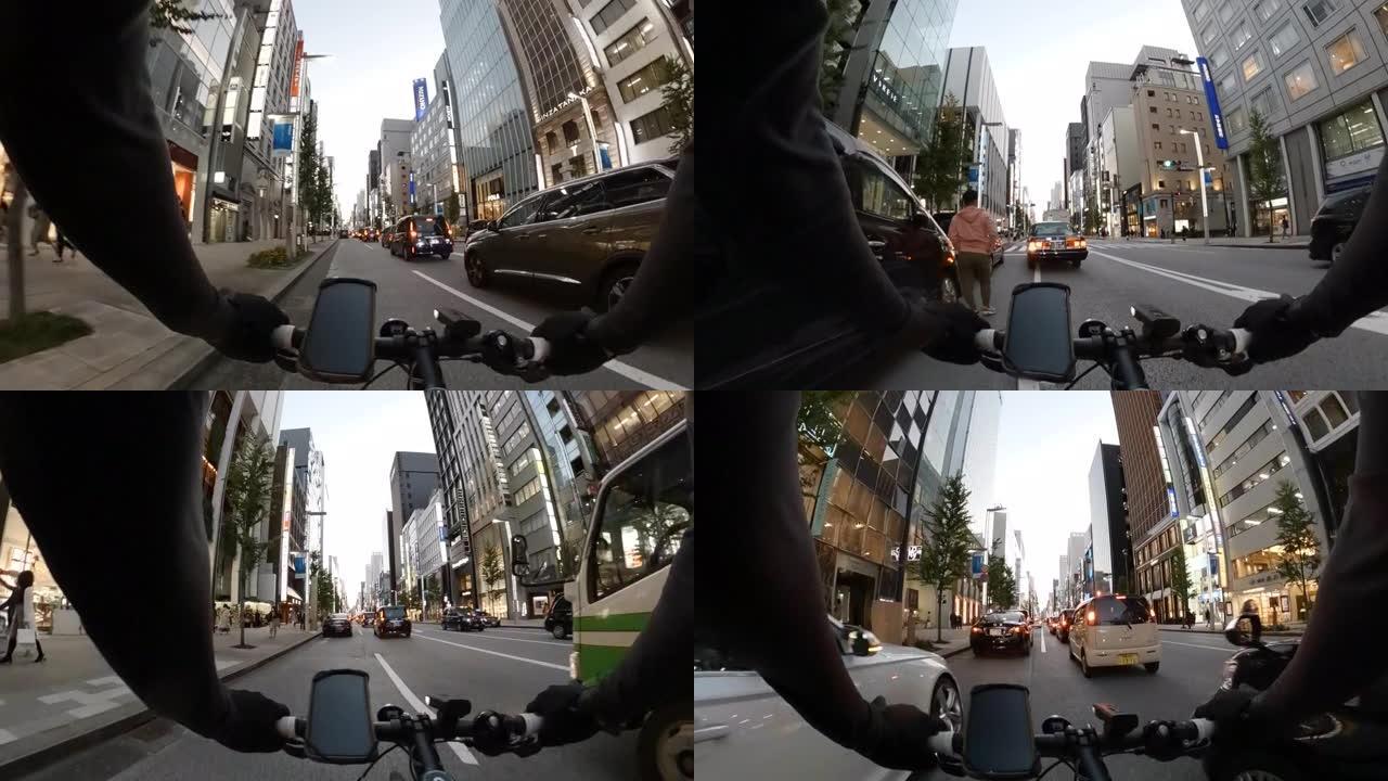 POV在城市里骑自行车。骑自行车穿越日本东京银座。交付服务的概念。