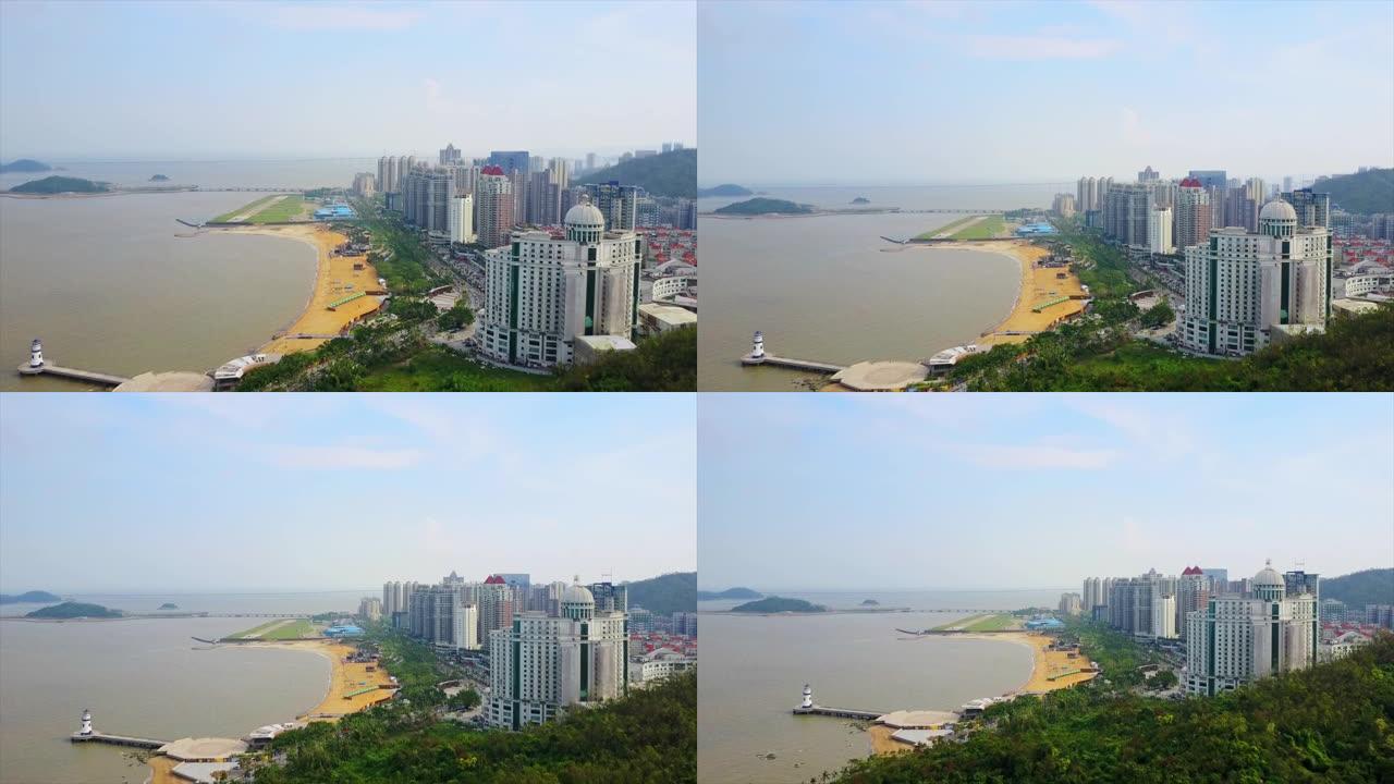 阳光明媚的日子珠海市著名的海滩湾灯塔空中全景4k中国