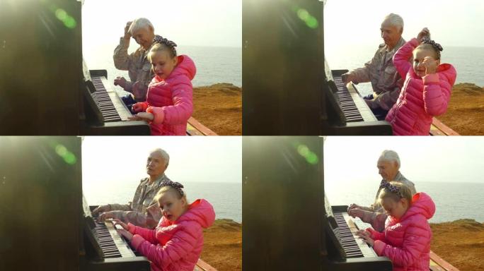老人和小女孩在岸上的旧钢琴上一起演奏