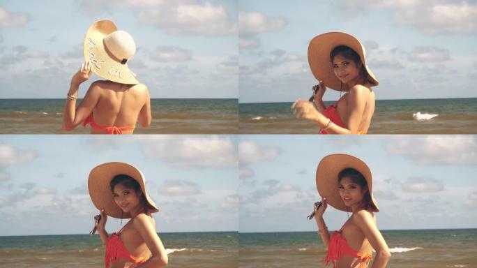 在海滩上散步的亚洲女人。美丽的亚洲女性在泰国海滩上快乐放松