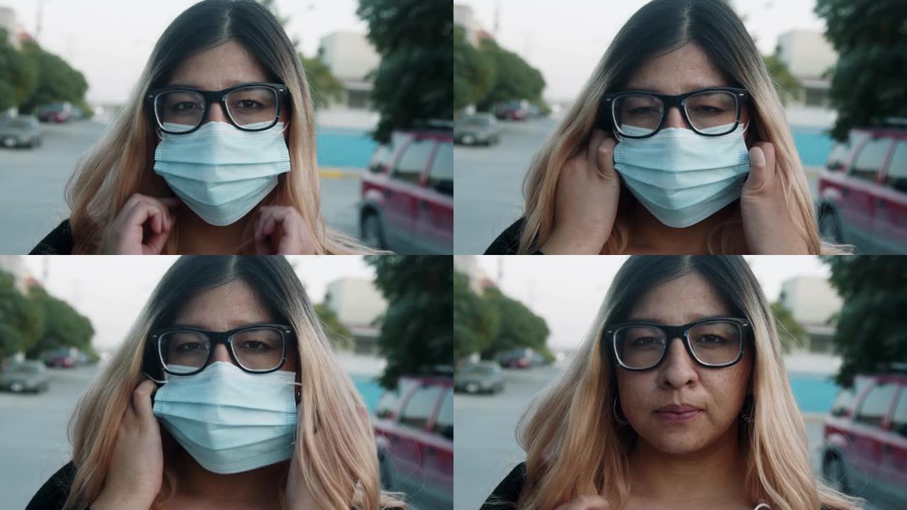 墨西哥年轻女子在墨西哥奇瓦瓦州北部城市华雷斯摘掉她的N95新型冠状病毒肺炎面罩，用于拉平曲线并减缓日