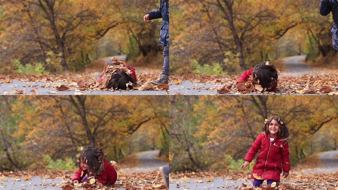 小女孩在秋叶里玩耍