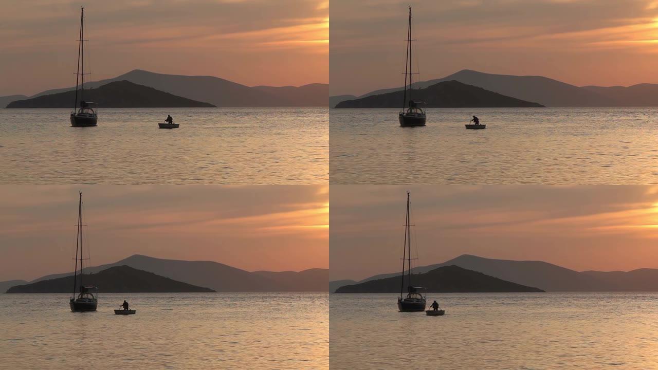 日落时独自帆船。橙色阳光的大气海景。