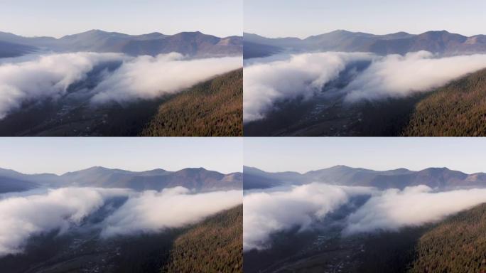 从鸟瞰图看，黎明时分，两大片移动的云层覆盖了山谷。