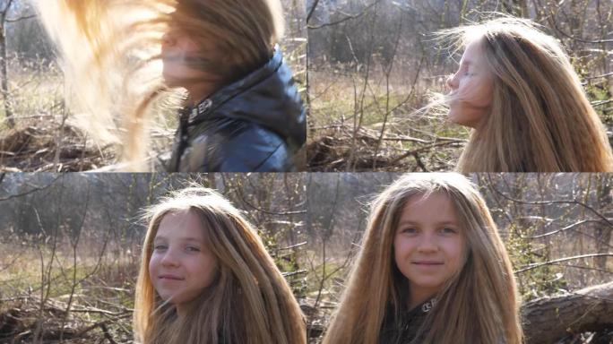 无忧无虑的小女孩抬起头，在空中挥舞着长长的金发。早春时，美丽的女婴在森林模糊的背景下看着相机的肖像。