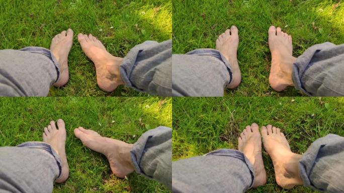 马德里西公园草地上的成年男性赤脚
