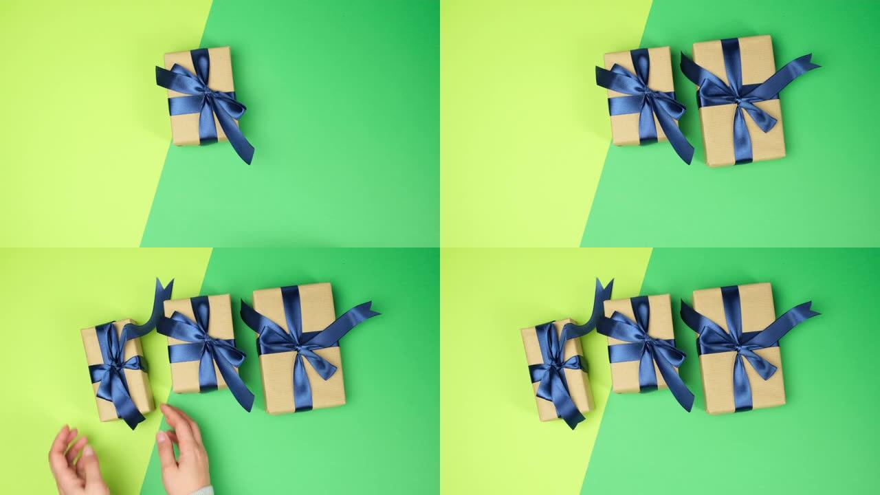 女性手戴上绿色表面包裹的礼物，蓝色系结丝带