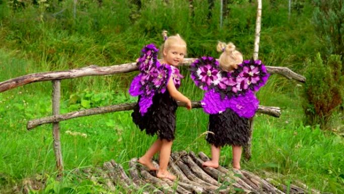 可爱的金发女孩，紫色蝴蝶翅膀站在木桥上