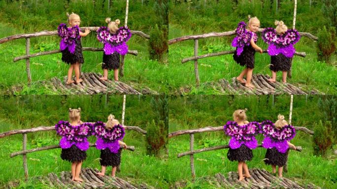 可爱的金发女孩，紫色蝴蝶翅膀站在木桥上