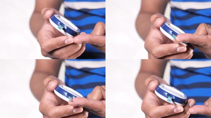 年轻人的手在家测量血糖水平