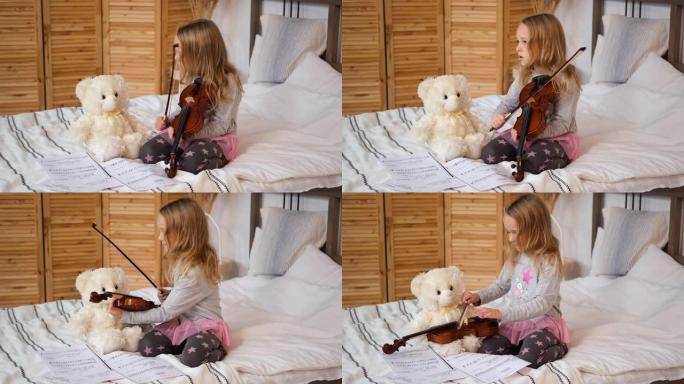教泰迪熊拉小提琴的小女孩
