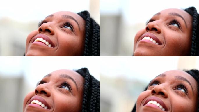 非洲女人仰望天空感受自由和幸福，黑人女孩特写脸