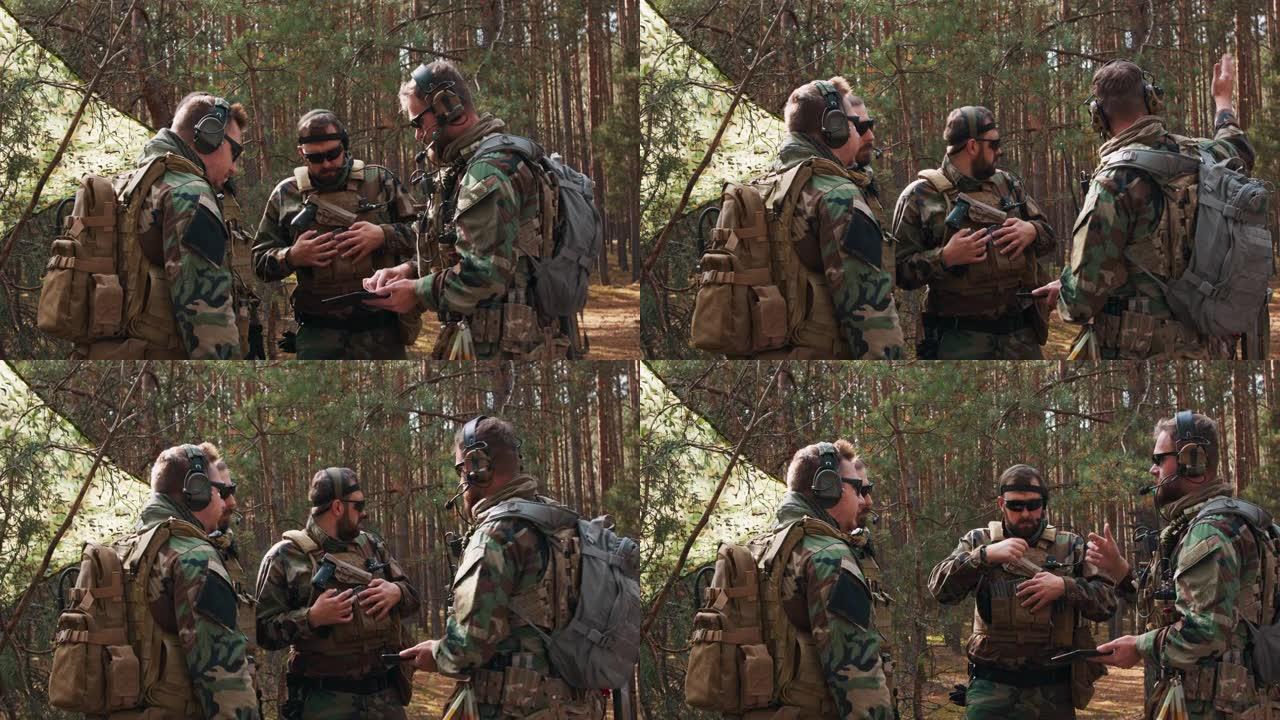 一群穿着制服和战术背心、蓄着胡须的中年士兵在一个临时森林基地讨论行动计划，并为行动做准备。指挥官使用
