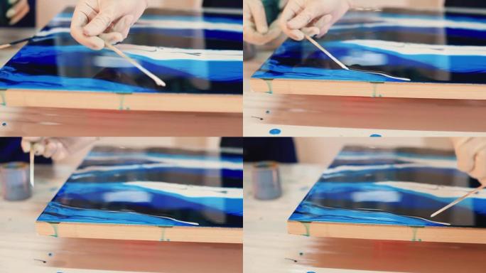 艺术家用工具手工制作污渍油漆。使用液体油漆硬质表面