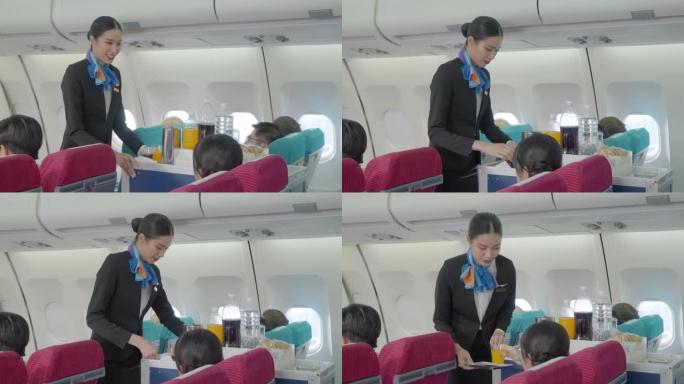 空姐在飞机上的航空公司工作人员在飞机上的客舱为经济舱的乘客提供食物和饮料。
