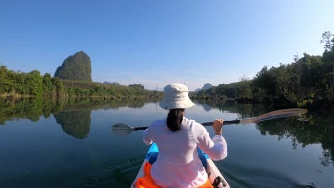 女人戴帽子第三人称视角在淡水泻湖皮划艇