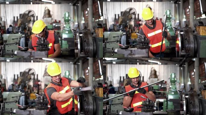 工人，工人穿着安全服，护目镜和安全帽正在控制钢机切割和测量钢板。背景非聚焦工业工厂。