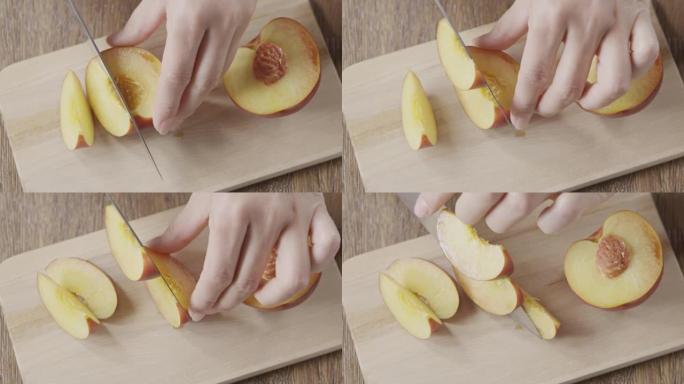 女人的手在木板上切成熟的桃子的视频。