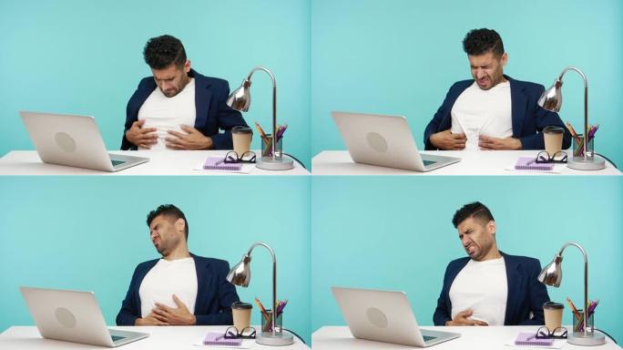 沮丧沮丧的上班族在使用笔记本电脑，便秘或胃灼热时感到胃部痉挛和抽筋
