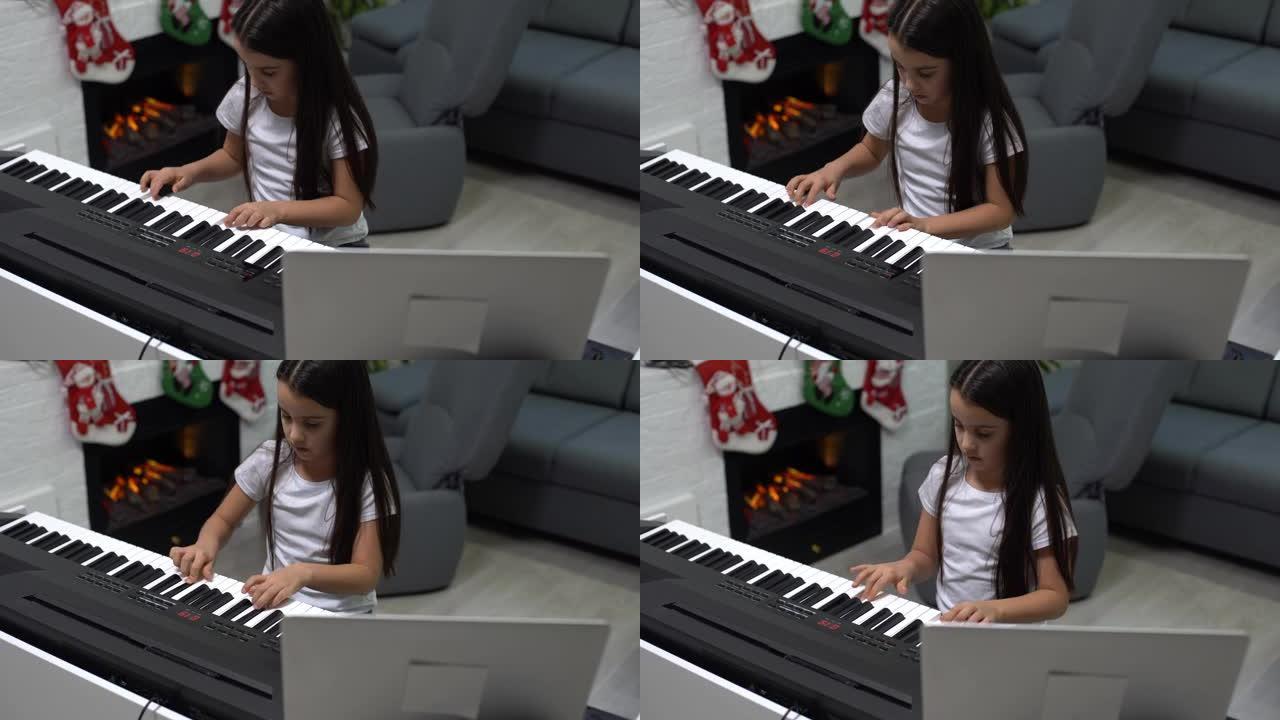 可爱的小女孩弹钢琴，背景装饰圣诞节。大流行期间的圣诞节庆祝活动