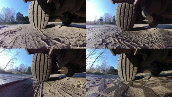 在土路上行驶时的汽车轮胎和悬架系统广角POV