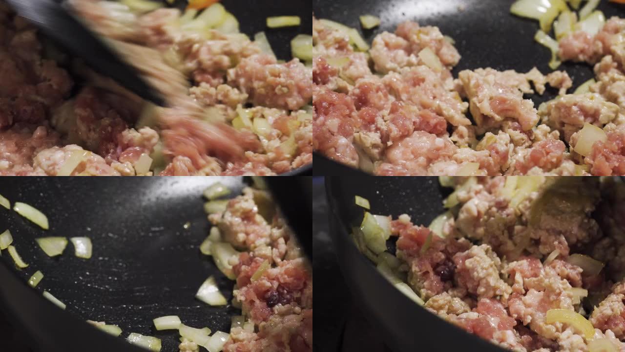 新鲜的猪肉末在洋葱平底锅上翻炒。宏观拍摄。准备制作意大利面菜单。