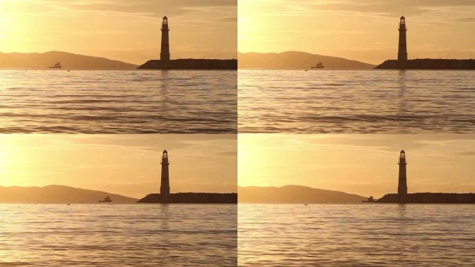 日落时的海景。海岸上的灯塔。海滨小镇Turgutreis和壮观的日落