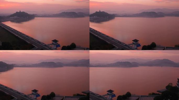 日出时巨大的姜太公雕像和天目湖的空中太公山