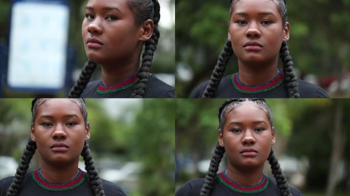 追踪非洲黑人妇女在外面看着相机的镜头，特写脸部肖像