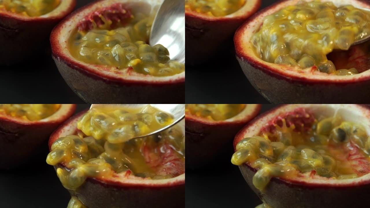 用多汁成熟的百香果颗粒关闭勺子。热带水果背景