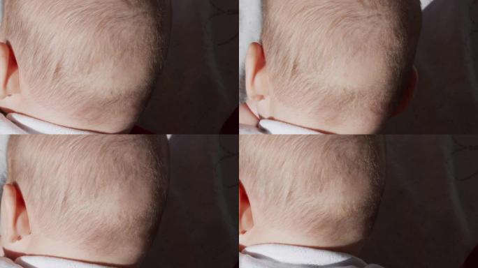 从后面看，小宝贝。头部后部的婴儿缺乏头发。