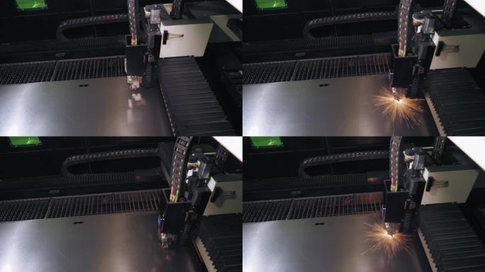 钣金激光切割机。顶视图。现代数控光纤激光器机器正在金属板上切割图案。切割过程中，明亮的燃烧火花从激光