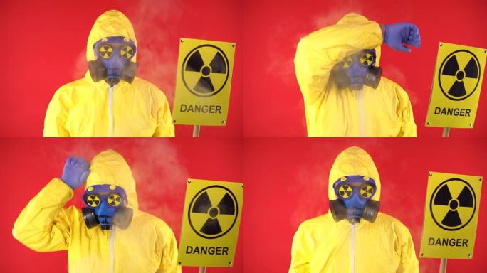 穿着防护化学服的男子，带有海报的防护面罩警告红色背景上的辐射。辐射概念