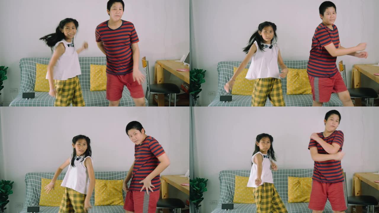 快乐的亚洲青春期男孩和他的妹妹一起在家练习舞蹈，生活方式理念。