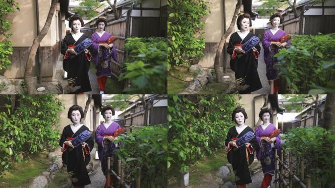 两个艺妓一起走在京都祗园狭窄的街道上——第二部分的第一部分