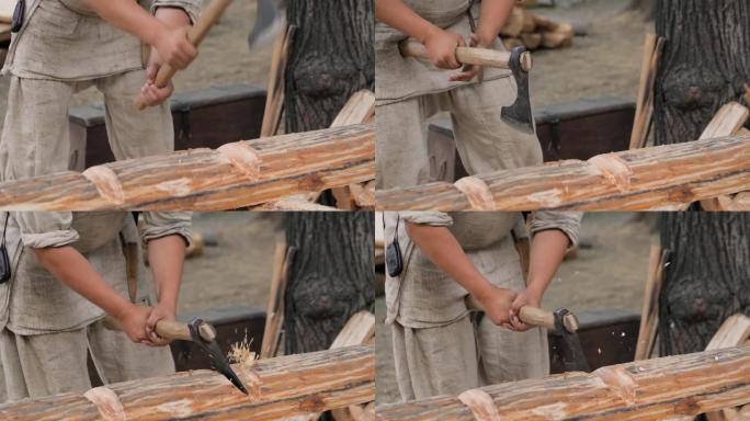 慢动作: 男子伐木工人在历史节日用斧头切割大原木