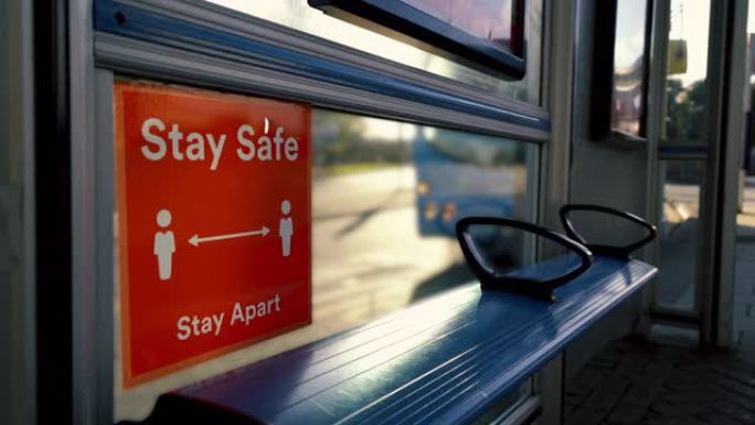 离开公共汽车时，在公共汽车站保持安全的大流行标志