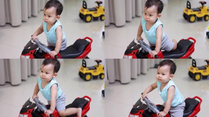 骑玩具摩托车的小男孩