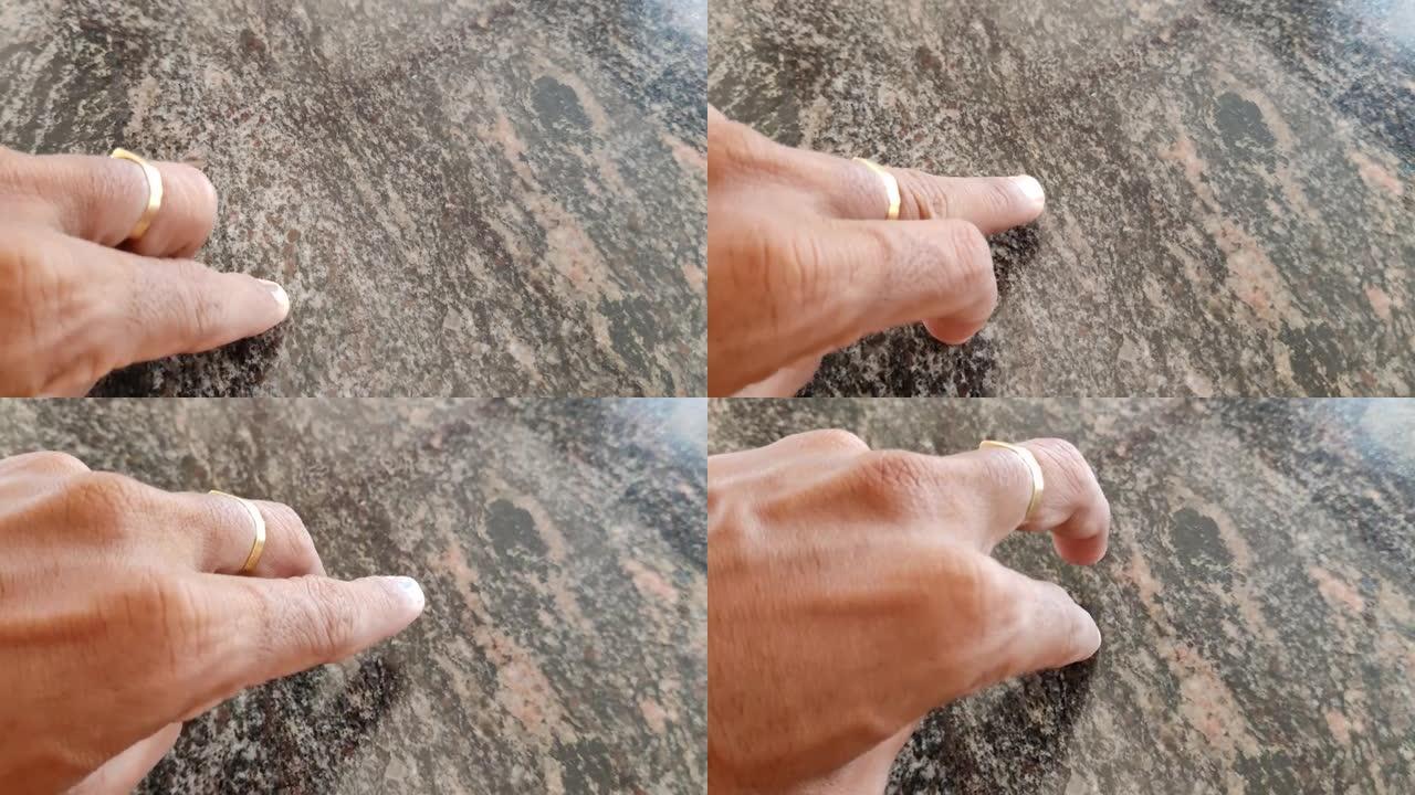 人类手指在花岗岩表面上方的运动