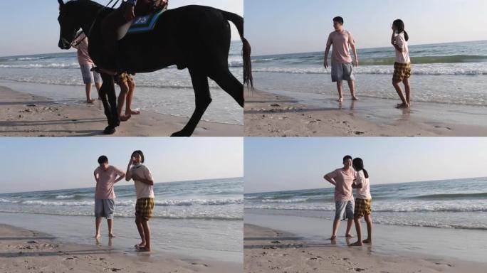 亚洲儿童在海滩上行走突然有一个女孩害怕并尖叫着骑着自己的海滩马。