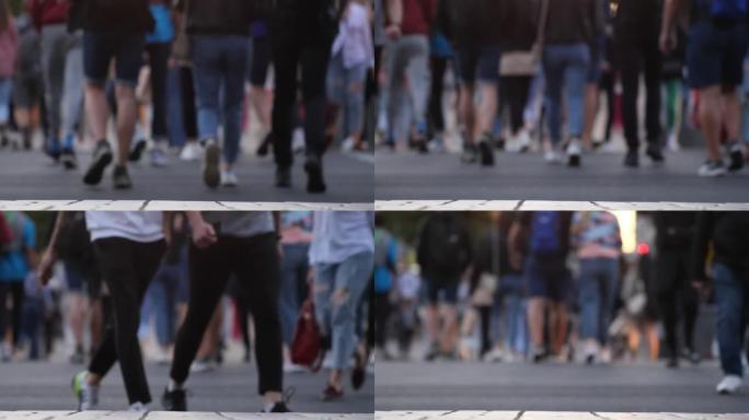 步行在街上的人群的脚。60 fps的慢动作。人群脚的特写。拥挤的人走在街上的镜头。城市人群。许多腿沿