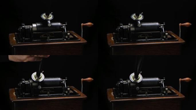 经典爱迪生留声机在黑色录音棚背景下通过喇叭播放音乐。复古复古机器重现听音乐的声音。特写。慢动作