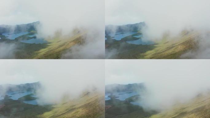 飞越火山顶部的云层。Caldeirao，Corvo，亚速尔群岛的绿色斜坡和湖泊