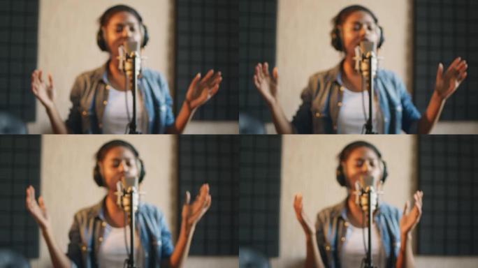 在sound record studio录制歌曲的非洲裔美国女歌手的模糊肖像