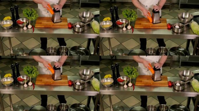 厨师在餐厅厨房用刨丝器切胡萝卜的特写镜头。
