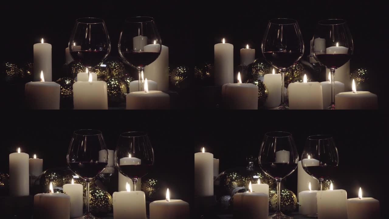 多莉·肖尔 (dolly shot) 在燃烧的蜡烛，圣诞节和新年装饰品的背景下配上红酒的玻璃杯