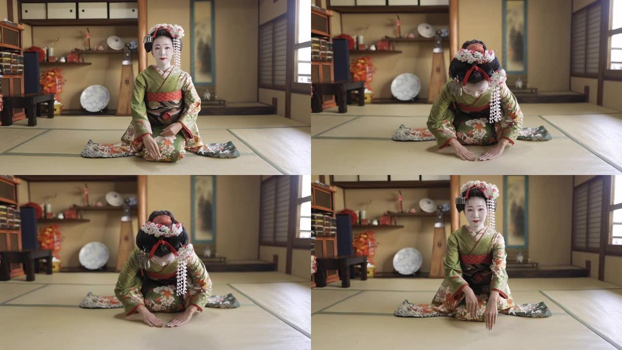 舞子 (训练中的艺妓) 坐在高跟鞋上，在日本榻榻米房间鞠躬