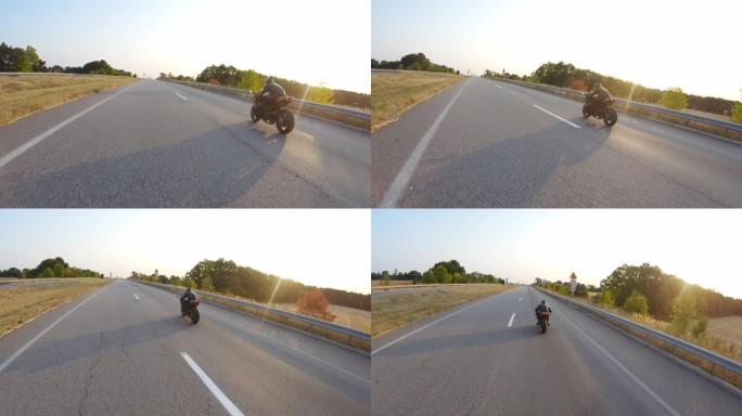 在阳光明媚的秋天，跟随骑自行车的人在高速公路上骑现代运动摩托车。摩托车手在乡间小路上骑摩托车。一个人