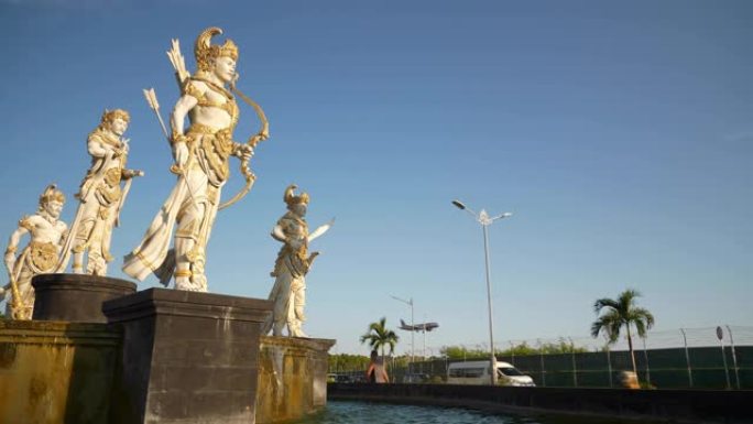晴天巴厘岛机场区街道喷泉纪念碑飞机降落慢动作全景4k印度尼西亚