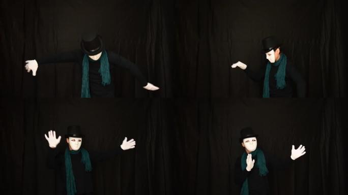 戴着白色面具的哑剧 -- 脸、帽子和白手套塑性跳舞，在黑色背景上表达感情。